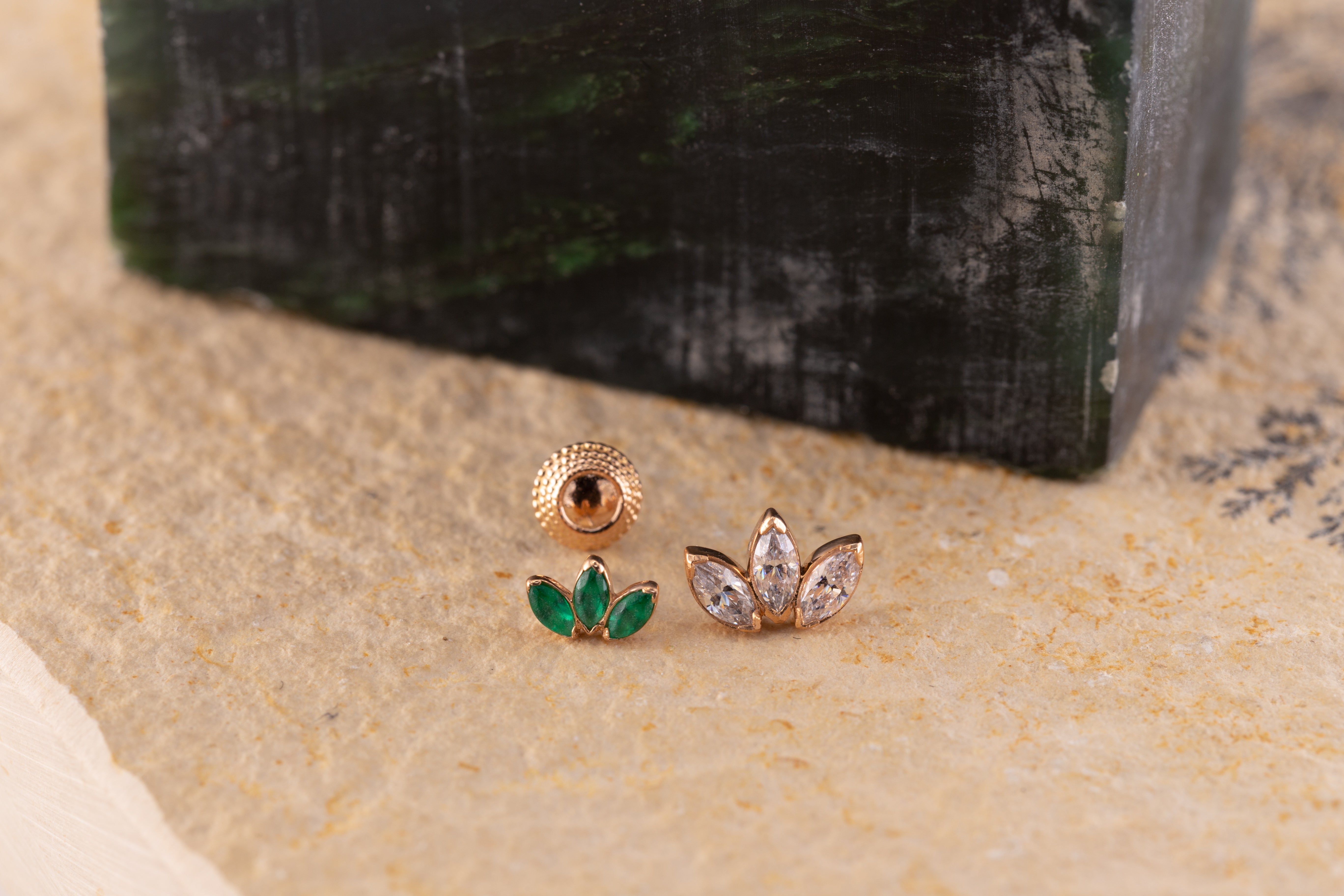emerald green gems in a body jewellery stud