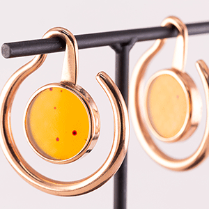 rose gold ear weights with yellow stone in the centre for ear piercings done at vancouver best piercing shop